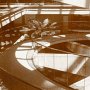 sepia photograph of spiral ramp descending into square opening